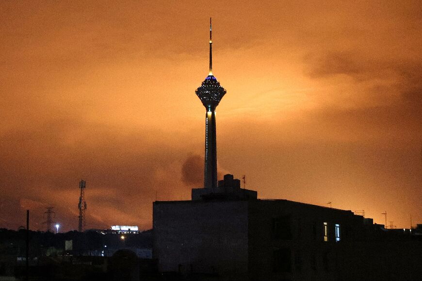 Skies around Tehran's Milad (Birth) Tower, the tallest tower in Iran, are lit up following airstrikes on March 7, 2026