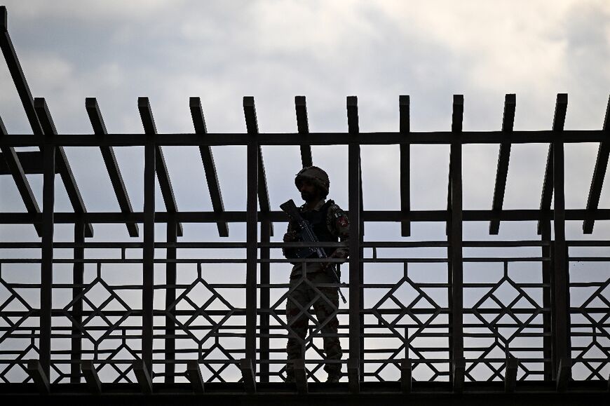 A Pakistani soldier stands guard at the Pakistan-Iran border crossing at Taftan