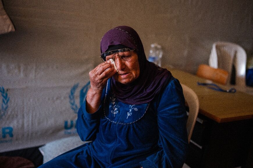An elderly displaced woman sits in her room at a school being used as a shelter for displaced people in the southern Lebanese city of Tyre 