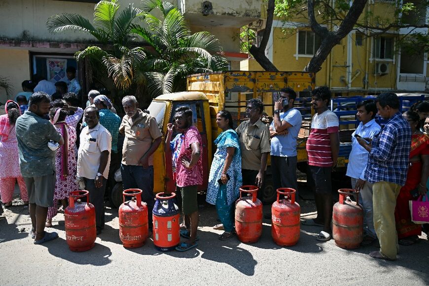 People queue to buy liquefied petroleum gas (LPG) cylinders for domestic use in Chennai on March 11, 2026