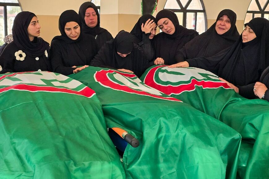 Mourners gather around the bodies of people killed earlier this week by Israeli airstrikes in the Lebanese coastal city of Tyre