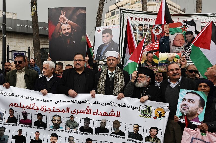 People protest in 2024 in Ramallah in support of Palestinian prisoners held in Israeli jails, including Israel's most high-profile detainee, Marwan Barghuti, photographed in handcuffs