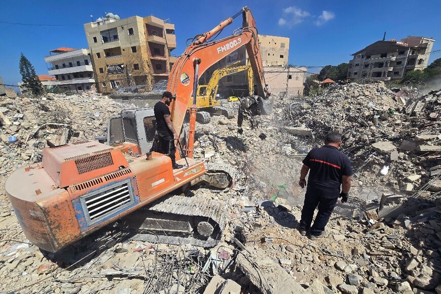 Diggers are used by rescue teams working to remove the rubble from a building previously hit by the Israeli army, in the southern Lebanese village of Hanaouay