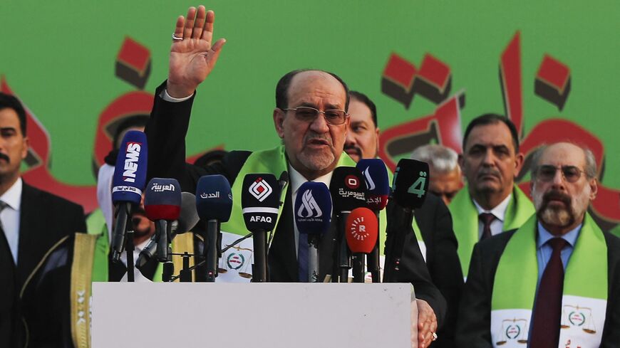 Former Iraqi prime minister Nuri al-Maliki (C) delivers a speech during a campaign rally for the State of Law Coalition ahead of the country's parliamentary elections in Baghdad on November 7, 2025. 
