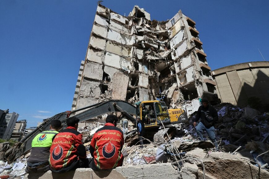 Lebanese rescuers clear the rubble at the site of an Israeli airstrike that targeted a building the day before in Beirut