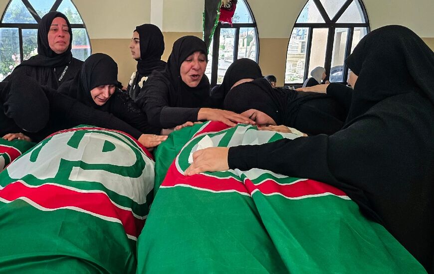 People mourn victims killed earlier this week by Israeli airstrikes in Abbasiyeh on April 10, 2026