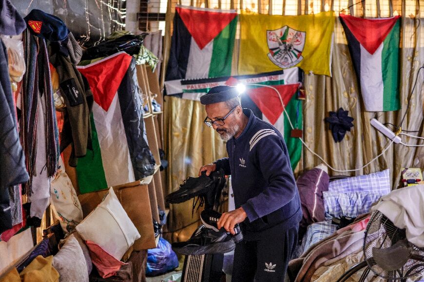 Abu Salah has made the most of his situation and decorated his walls with Palestinian flags