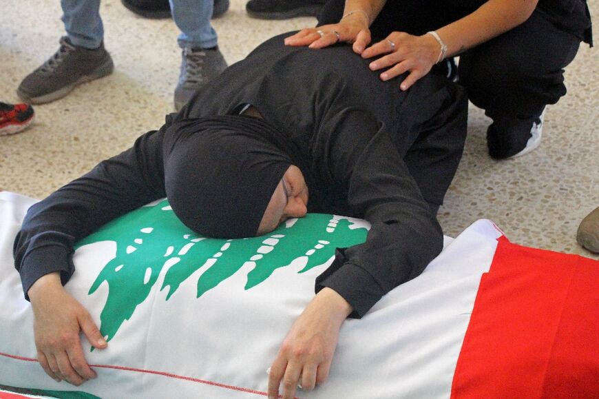 A mourner weeps over the body of a victim killed in a strike, before a funeral in Tyre, southern Lebanon on May 28