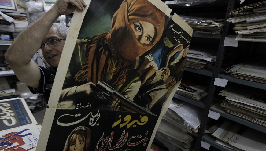 Lebanese movie poster collecter Abbudi Abu Jawdeh holds up a poster stored deep under Beirut's busiest shopping district which is home to a treasure trove of the Arab world's film history vintage film posters spanning some 80 years on June 17, 2010.
