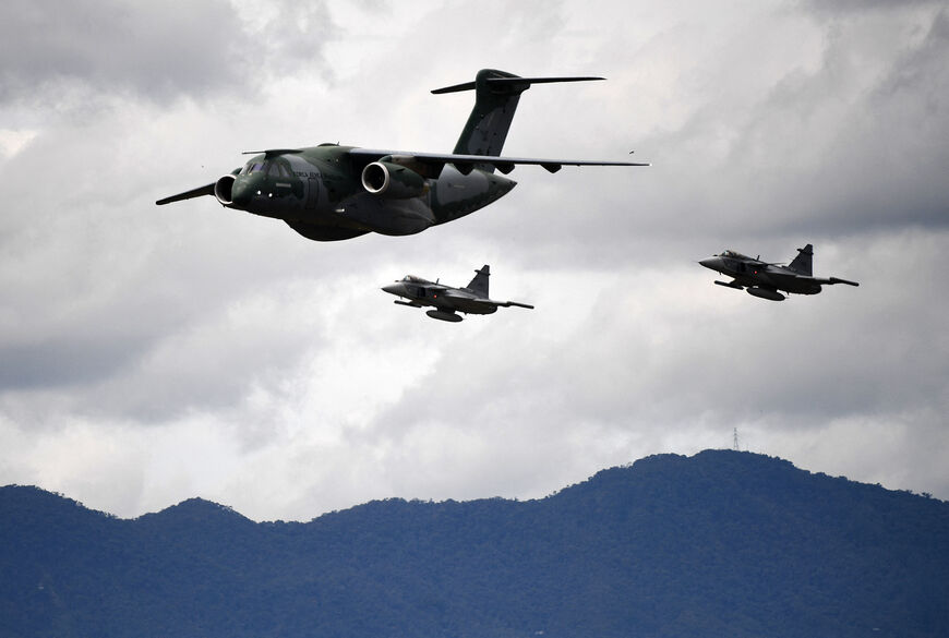 A Brazilian Air Force pilot with his Embraer C-390 Millennium aircraft, escorted by two Saab JAS 39 Gripen fighters, performs during the F-Air Colombia 2025 airshow in Rionegro, Antioquia Department, Colombia, on July 11, 2025. (Photo by JAIME SALDARRIAGA / AFP) (Photo by JAIME SALDARRIAGA/AFP via Getty Images)