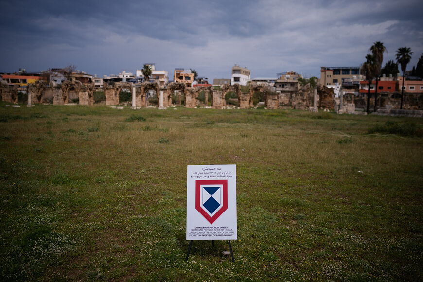 An Enhanced Protection Emblem, a special symbol used under international humanitarian law to protect critical sites during armed conflict, is displayed at the archaeological site of the Roman hippodrome in the southern Lebanese city of Tyre, on March 23, 2026. At the achaeological site of Al-Bass, in Lebanon's Tyre, there is no military defence, only a small sign bearing a blue and white emblem: the bulwark meant to protect the ancient ruins from Israeli bombs. One of the oldest cities in the Mediterranean 