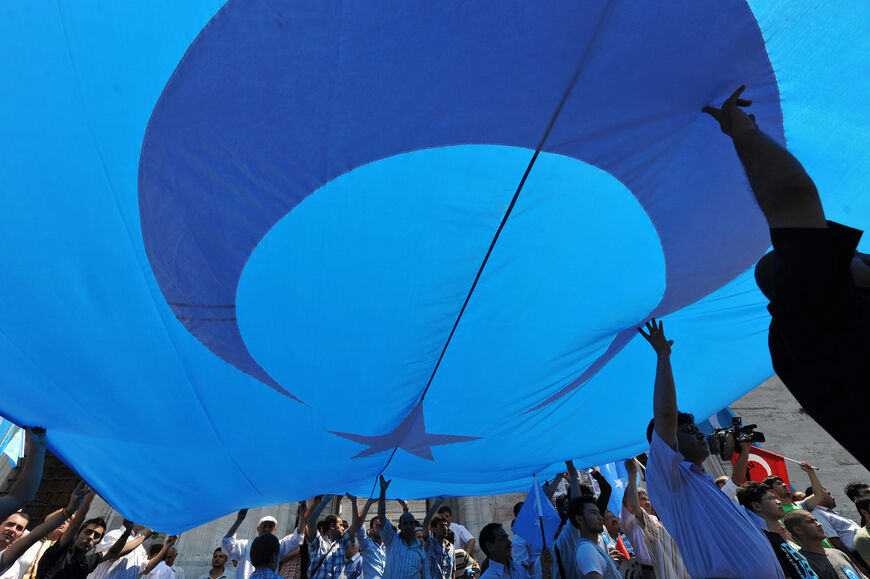 Protesters carry a giant eastern Turkestan flag during a demonstration after a Friday pray at the Beyazit Square in Istanbul, on July 10, 2009. ( MUSTAFA OZER/AFP via Getty Images)