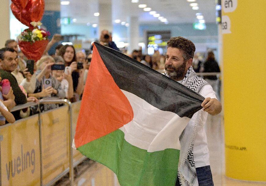 Spanish activist Saif Abu Keshek waves a Palestinian flag as he arrives at Barcelona airport, on May 10, 2026