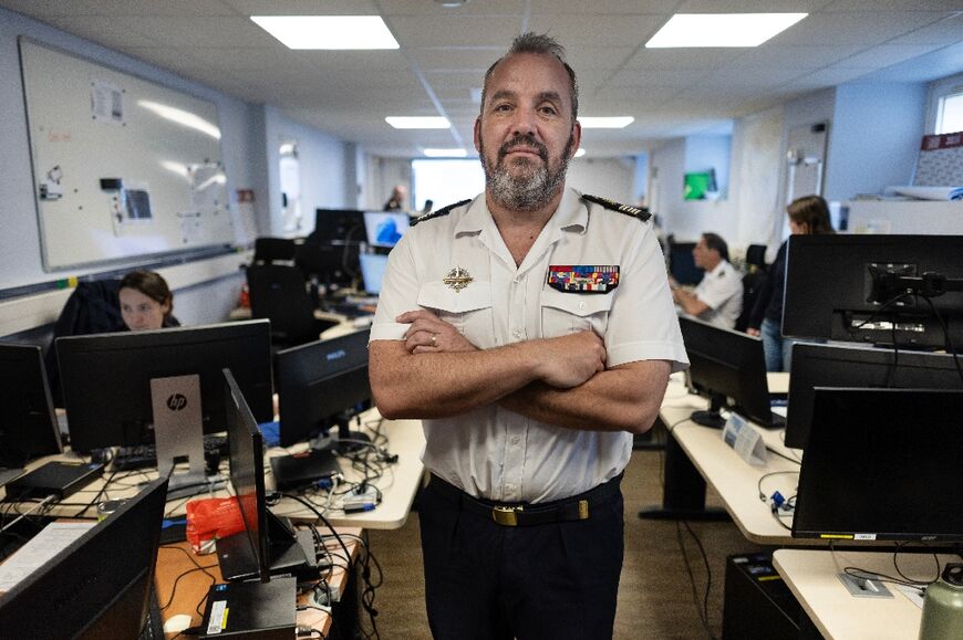 Commanding officer Thomas Scalabre oversees the monitoring