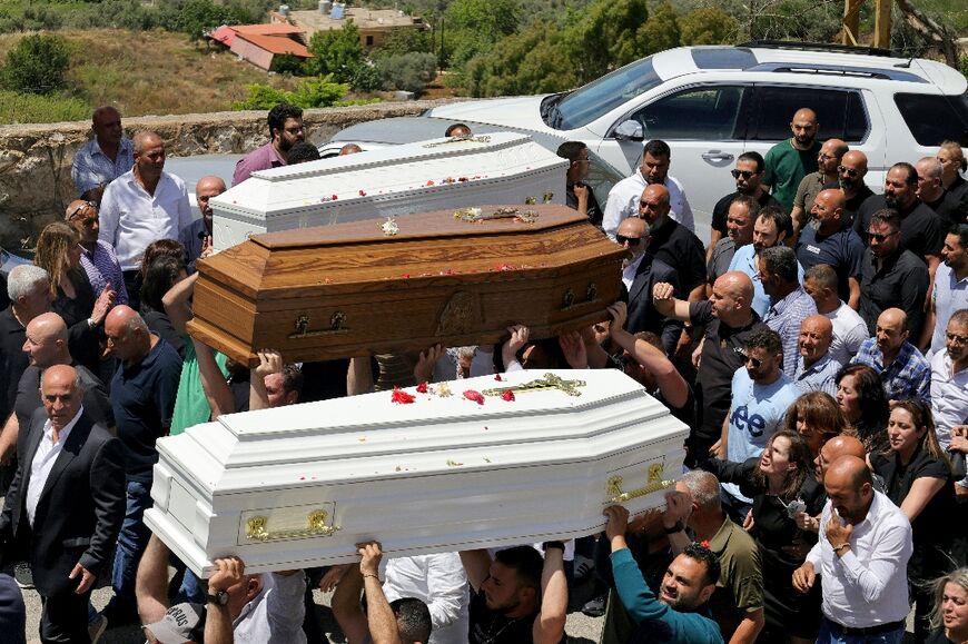 Relatives and friends of a man who was killed along with his son and daughter in an Israeli strike in southern Lebanon attend their funeral in the Christian border village of Qlayaa on June 3, 2026