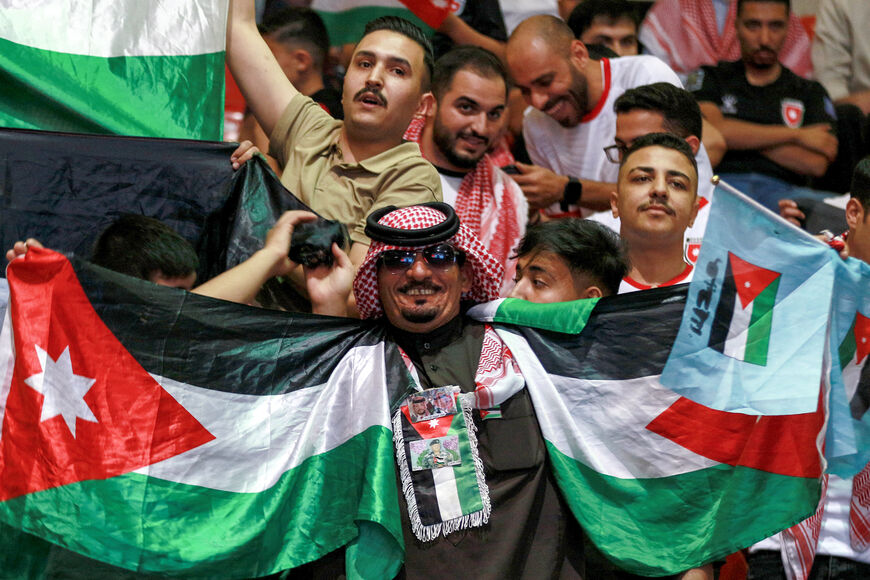 Jordan's fans cheer as they watch the 2026 FIFA World Cup Asian Qualifier football match between Jordan and Oman on big screens at the Prince Hamza hall in the Sports City in Amman on June 5, 2025. (Photo by Khalil Mazraawi/AFP via Getty Images)