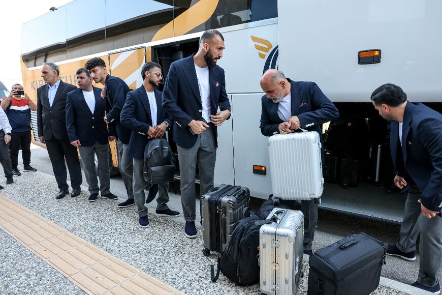 Iran midfielder Roozbeh Cheshmi (C), midfielder Mehdi Ghayedi (C-L) and other members of the country's World Cup squad arrive at the Antalya airport to fly to Mexico ahead of the tournament 