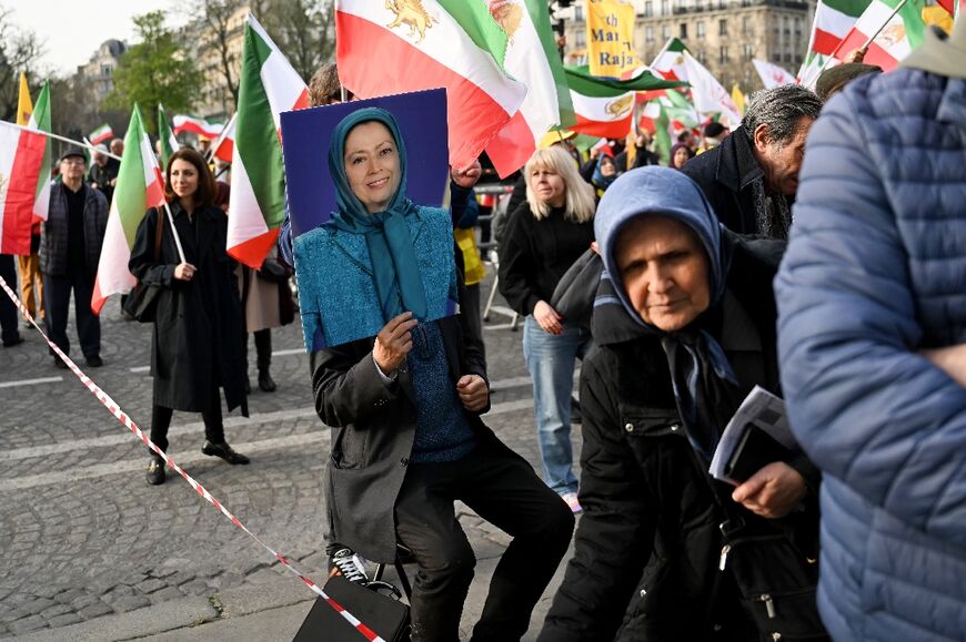 A supporter of the People's Mujahedin holds a portrait of leader Maryam Rajavi during a rally in Paris in March