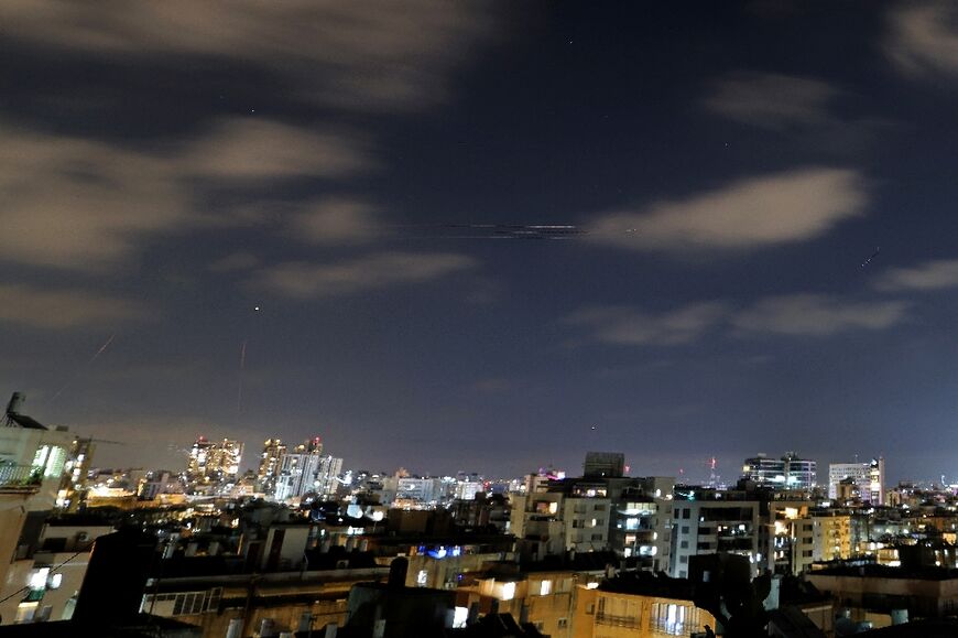 Rocket trails are seen above the Israeli coastal city of Netanya, as air raid sirens sounded in the country to warn of incoming Iranian missiles for the first time since an April 2026 ceasefire took hold in the Middle East war