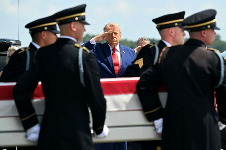 US President Donald Trump salutes as an Army team carries the flag-draped case containing the remains of Lieutenant Tyler Feehan, 25, of Ewa Beach, Hawaii