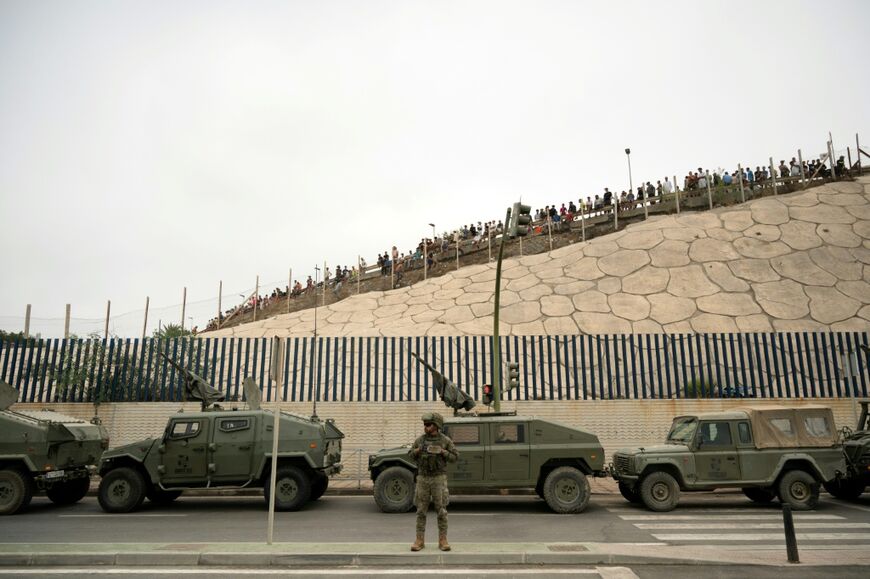 Spain rushed troops, more police, drones, divers and boats to Ceuta