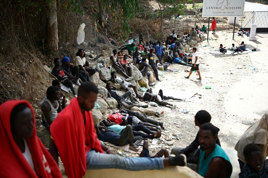 Crowds of migrants - pictured here on August 1, 2026 - slept rough outside Ceuta's full migrant centre