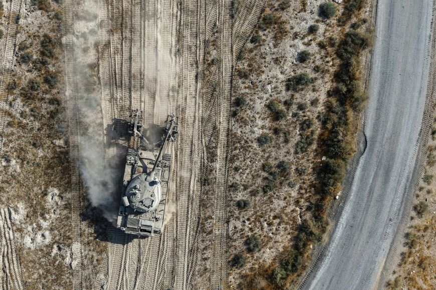 This aerial picture shows a Syrian defence ministry mine-clearing tank taking part in an operation to clear land mines in Qarah in the Damascus countryside