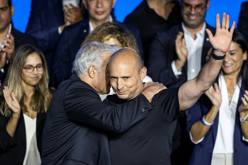 Former Israeli prime minister and opposition leader Yair Lapid (centre-left) embraces former Israeli prime minister Naftali Bennett in Tel Aviv on September 6, 2026