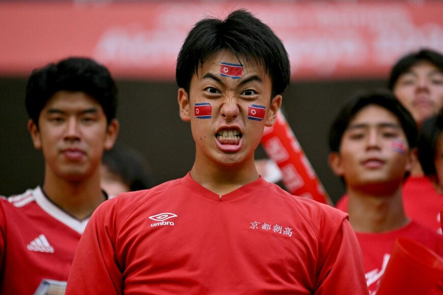 Fans with North Korean flags at the football
