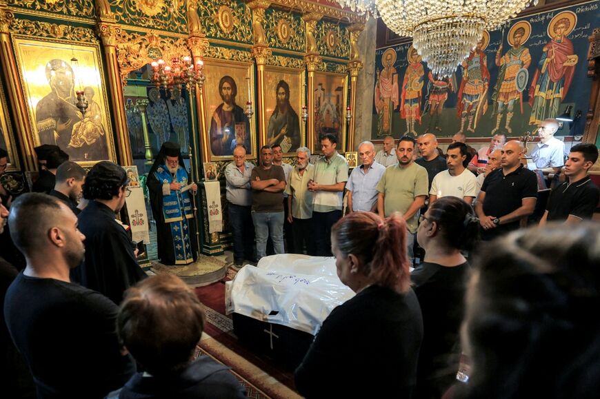Greek Orthodox Archbishop Alexios of Tiberias prays during the funeral of Maysaa Abu Daoud and her daughter Mary al-Najjar, who were killed in a strike on a residential building in Gaza that Israel said targeted the top Hamas leader in the territory