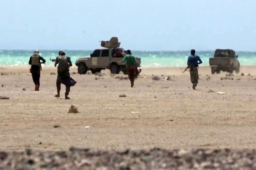 This screen grab taken from video footage released by the pro-Yemeni government Southern Giants Brigades on October 6 reportedly shows fighters near the Red Sea shore in Taiz province