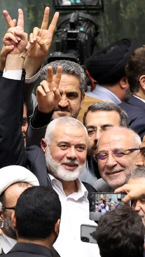 Hamas political leader Ismail Haniyeh flashes a victory sign during the swearing-in of Iranian President Masoud Pezeshkian hours before his death in an air strike in Tehran