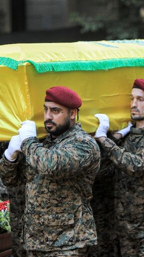 Hezbollah pall-bearers carry the coffin of Radwan Force commander Ibrahim Aqil